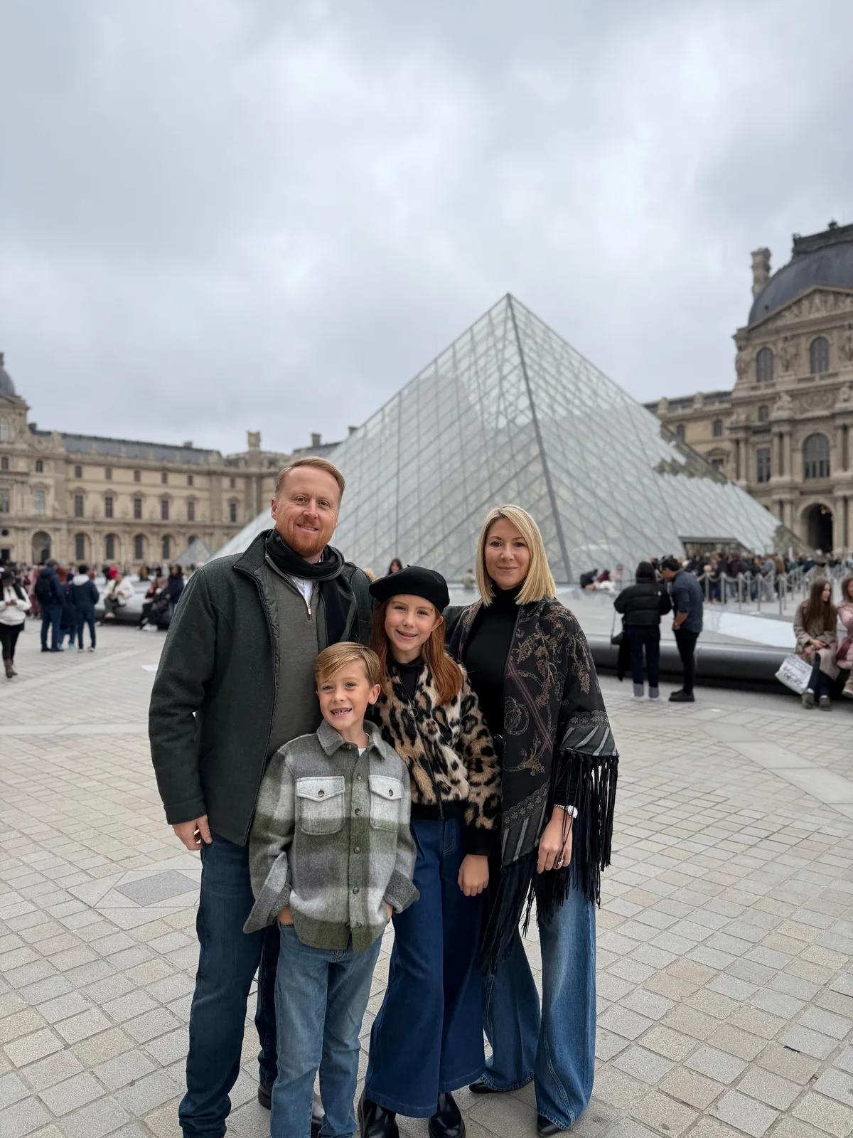 Ben Garton and his family at the Louvre Museum in Paris, in front of the glass pyramid
